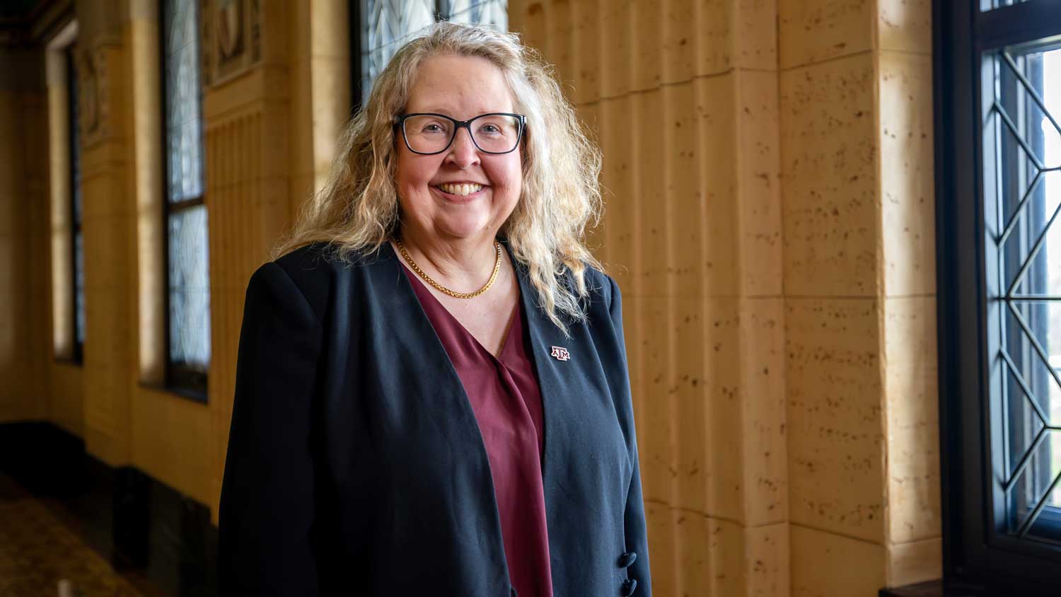 Angela Wilson posing by the windows inside the Jack K. Williams Administration Bulding